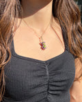 Person wearing a necklace with a colorful pendant