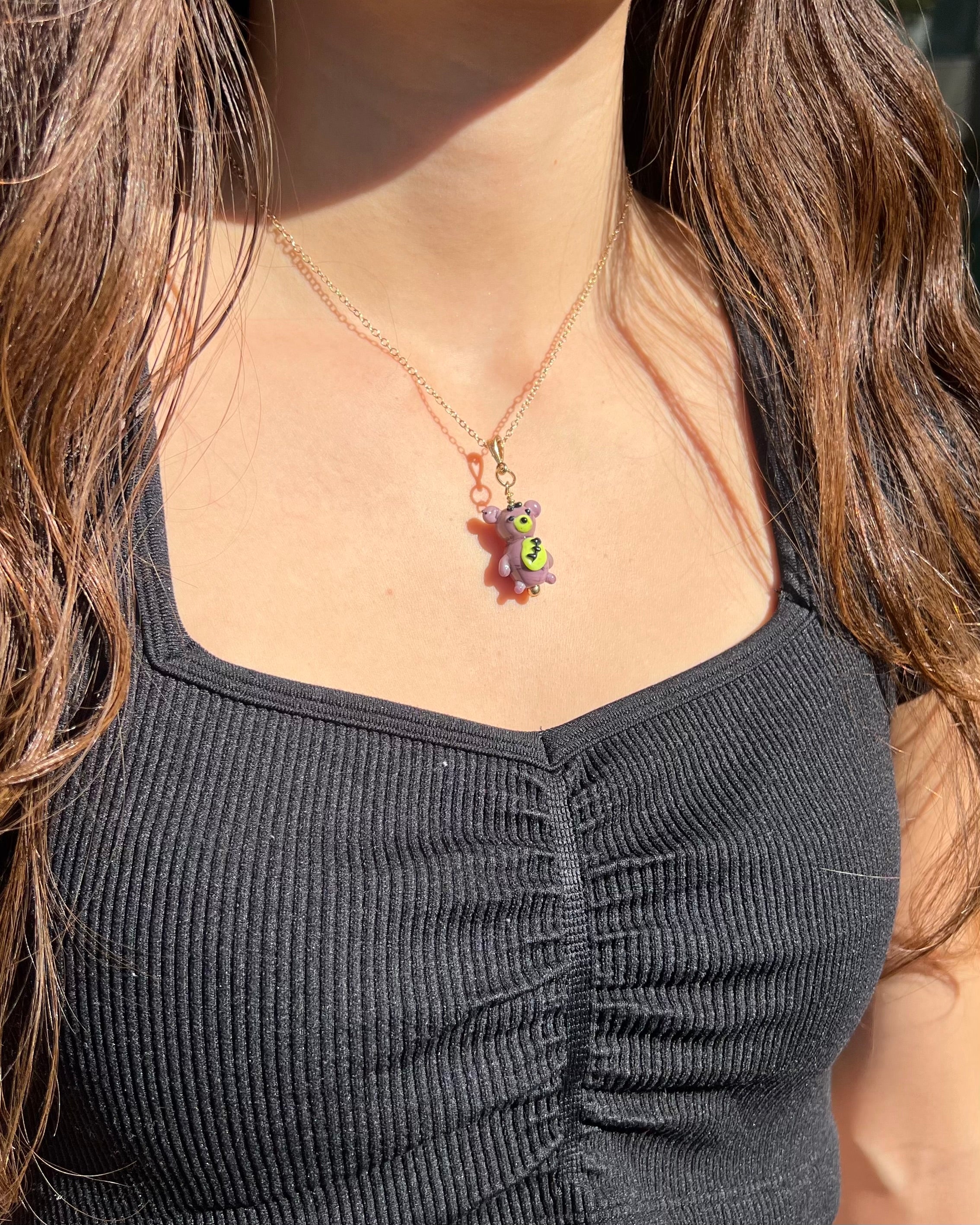 Person wearing a necklace with a colorful pendant